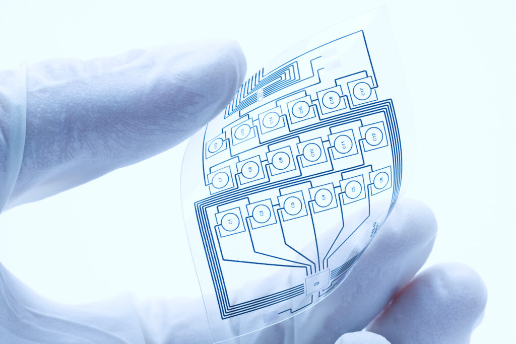 Technician holding a flexible electric circuit, RoLA-FLEX project.